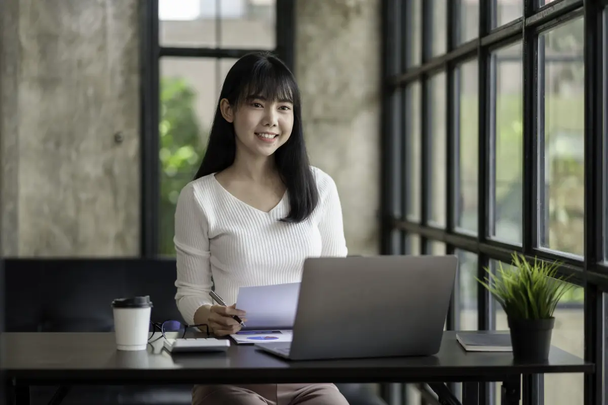 businesswoman-working-at-desk-with-laptop-smiling-2026-01-08-08-24-21-utc (1).jpg